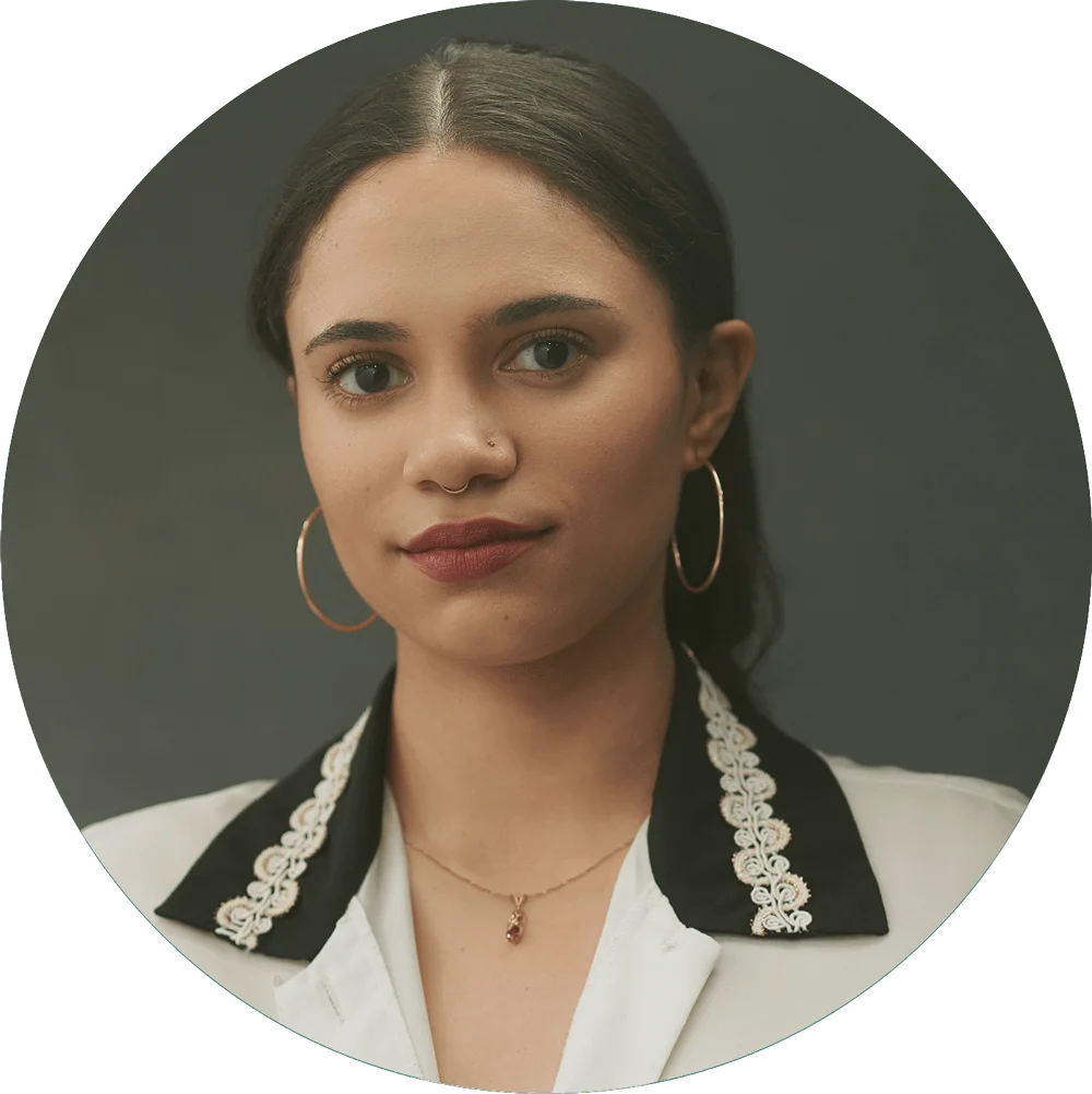 Chelsea, modeling headshots client, in two-tone blazer with white lace collar against grey studio backdrop