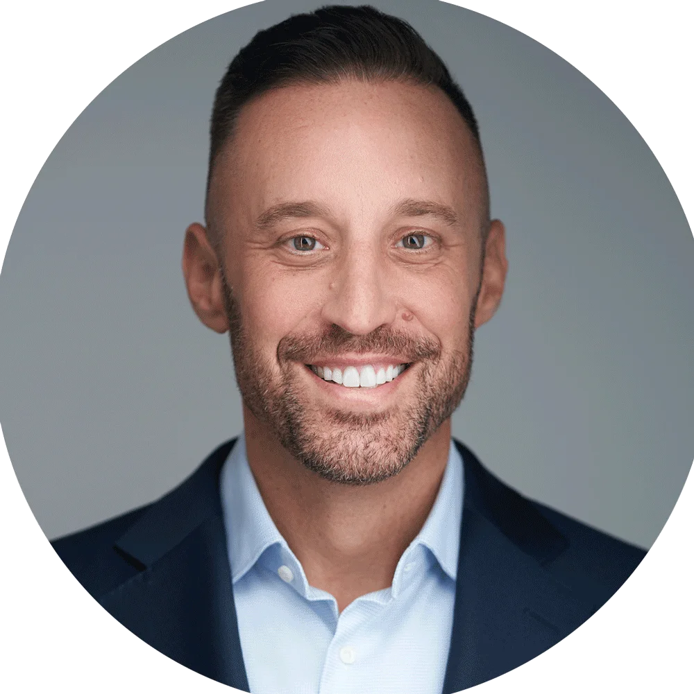 Brandon, business headshots client, confident headshot in navy blazer and light blue shirt against neutral gray background