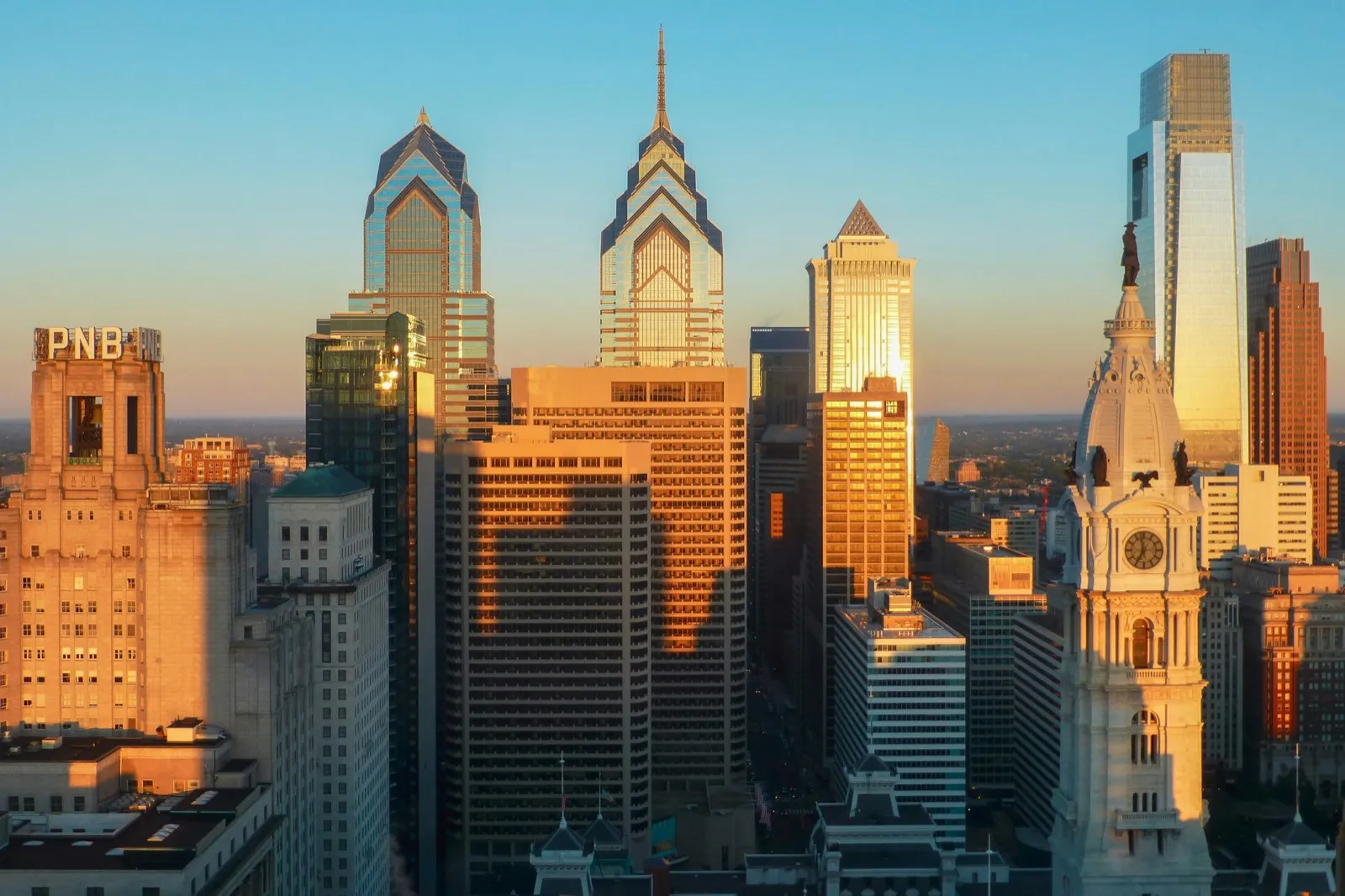 Philadelphia skyline at golden hour with City Hall and Liberty Place