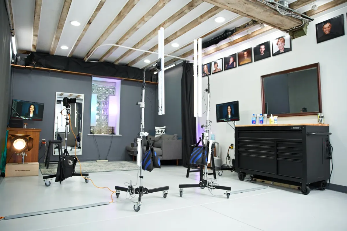 Professional headshot studio with lighting equipment and backdrop setup showing what a typical photography session environment looks like