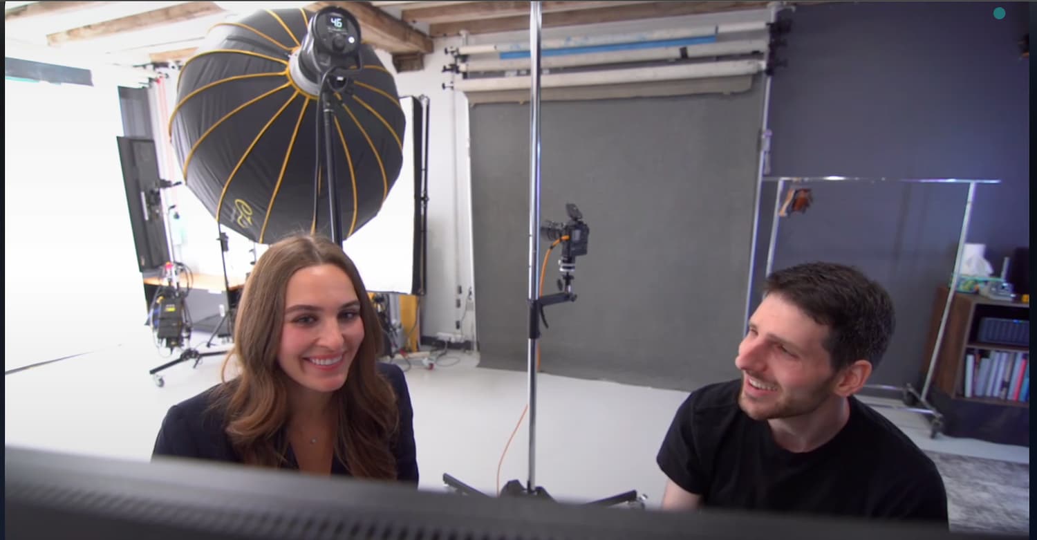 Photographer and client reviewing images together in studio