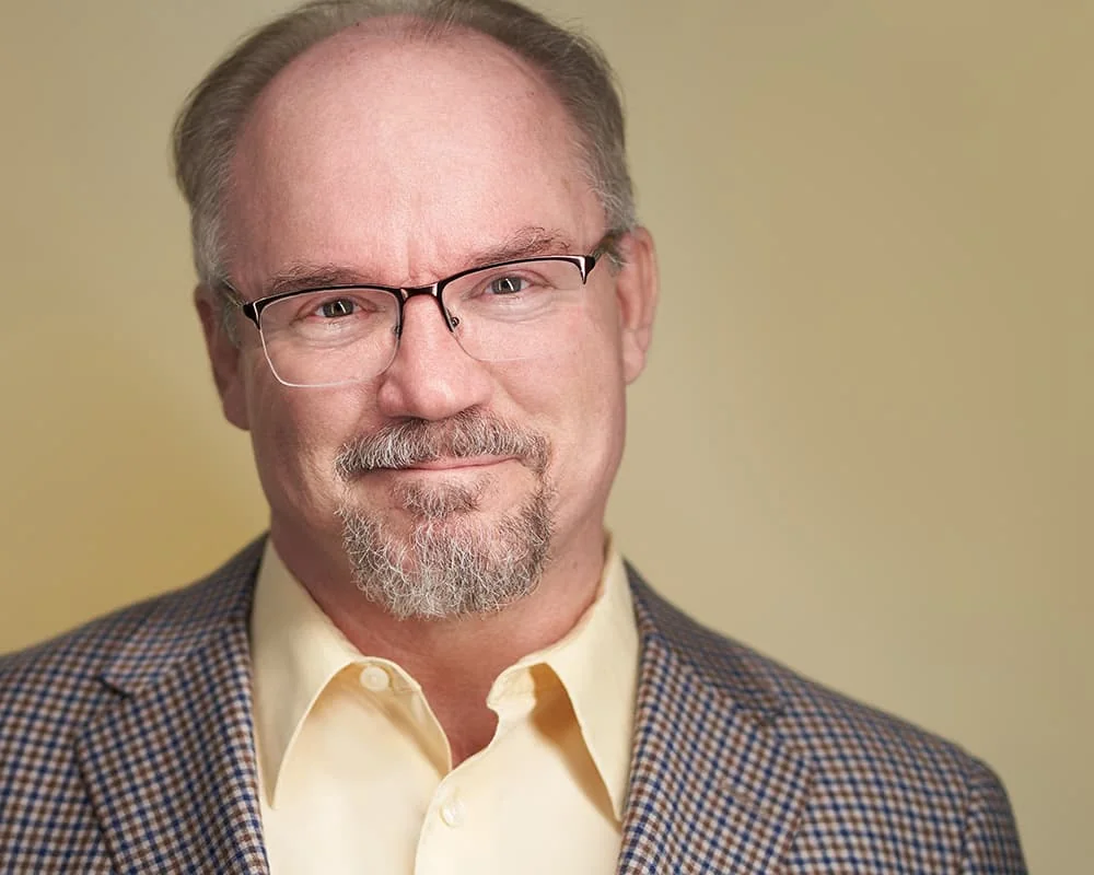 Professional headshot on a yellow background by MHamiltonVisuals