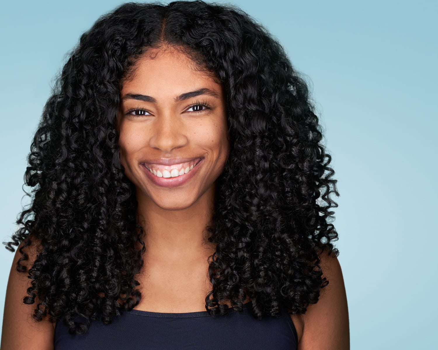Model-Headshot-Smiling-Light-Background African American Model Headshot Smiling on Light blue background