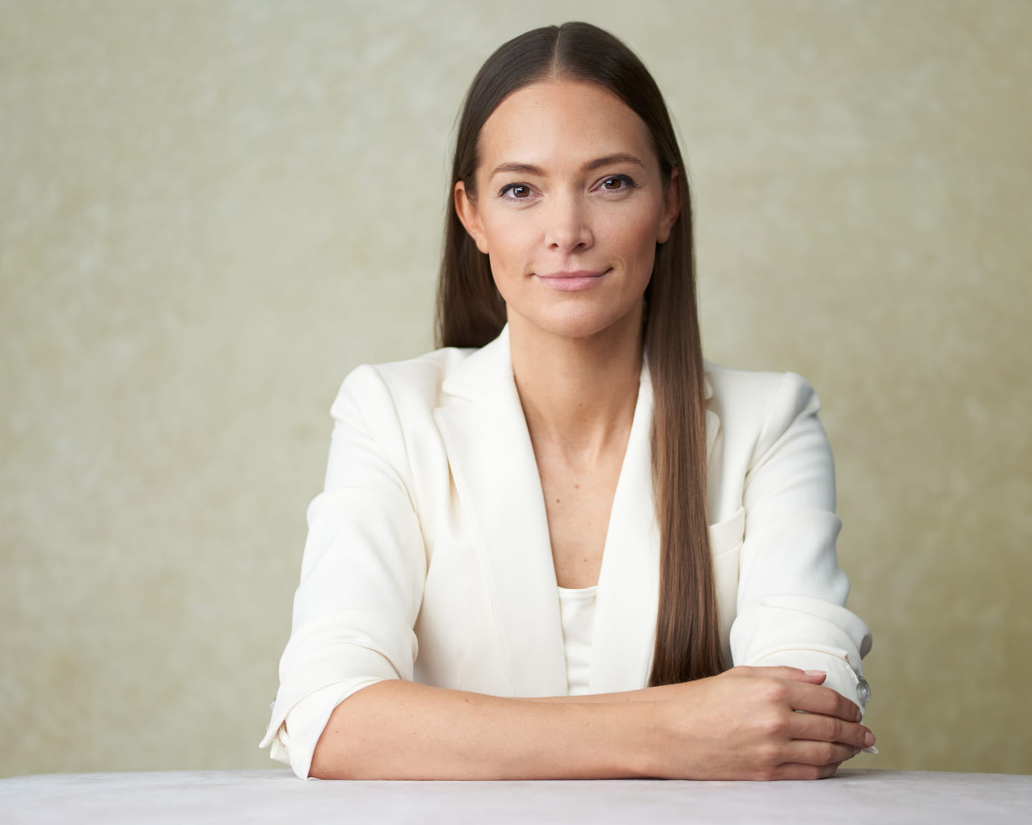 Executive portrait of businesswoman in white blazer - studio business photography